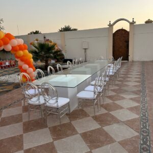 Glass table with Ghost acrylic chairs 10 pax