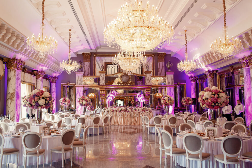 Luxurious dinner hall with large crystal chandeliers hanging from the ceiling